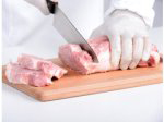 Einweghandschuhe beim Fleisch schneiden